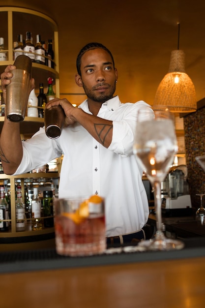 Vertical photo of a latin bartender making coktails