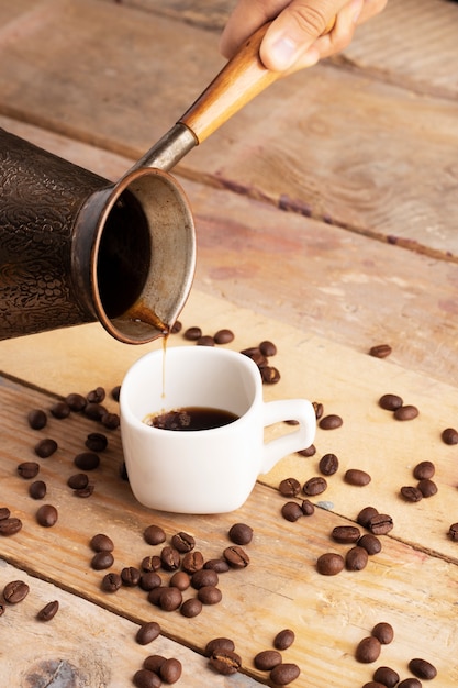 Vertical photo of pouring coffee to cup