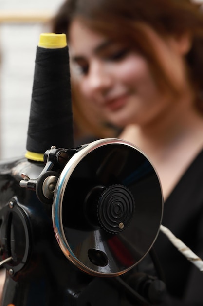 Vertical photo of sewing machine with young girl