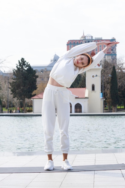 Vertical photo of young athlete stretching her body High quality photo