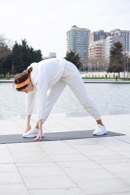 Vertical photo of young girl doing routine exercises High quality photo