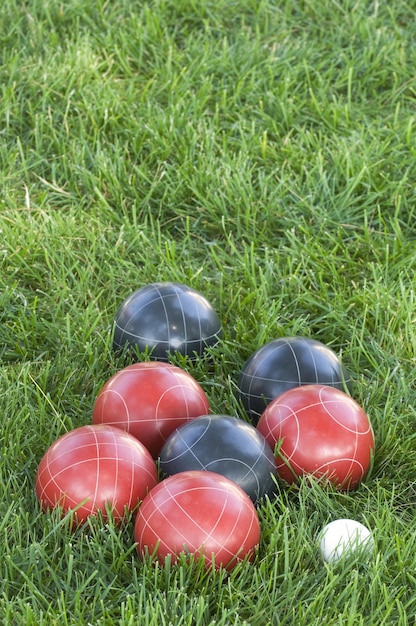 Vertical picture f colourful bocce balls on the lawn under the sunlight