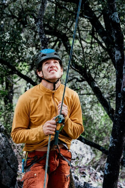 Vertical picture of one climber holding security rope from another team member