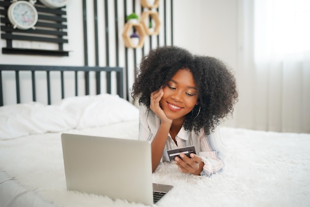 Vertical portrait of an africanamerican young woman relaxing in her bed Serene calm african