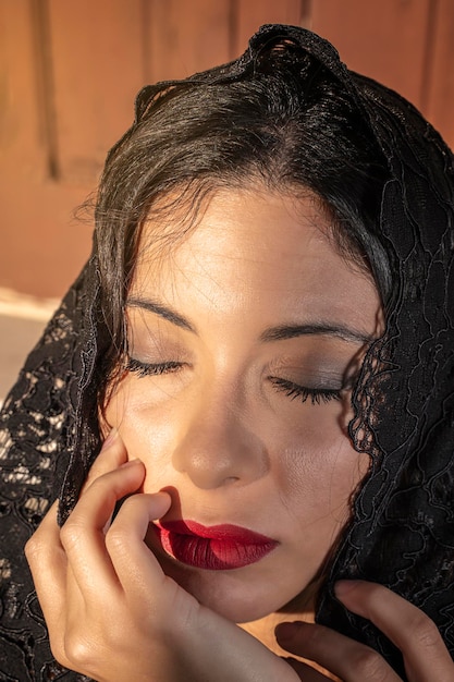 Photo vertical portrait of come-hither fashion young woman in black lace veil