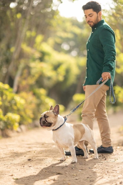 Vertical portrait of a man walking a dog