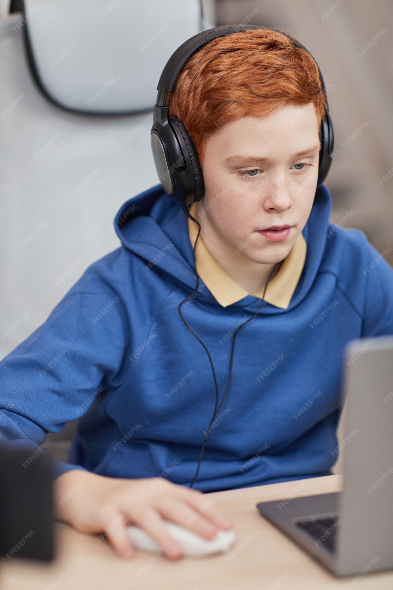 Teenager Boy Online Plays A Computer Game With Headphones And A