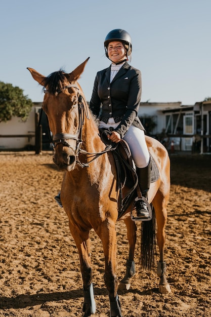 Vertical portrait of a student riding a horse from an equestrian school