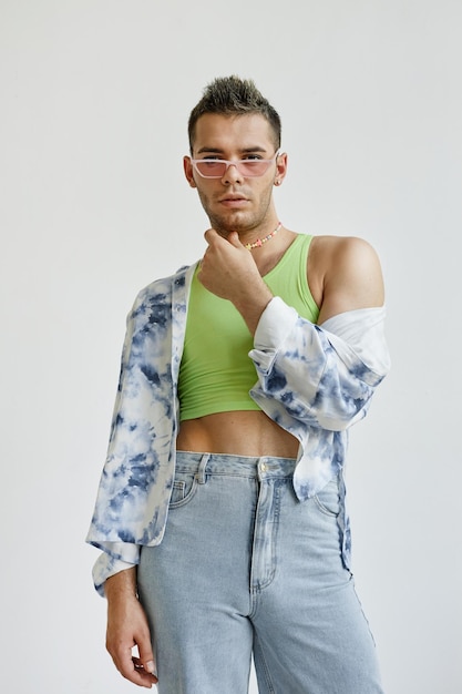 Logisk skære ned thespian Premium Photo | Vertical portrait of young gay man wearing extravagant  outfit with crop top against white in fashion