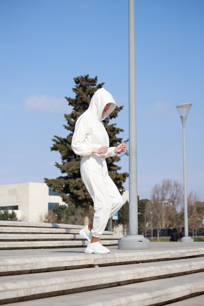 Vertical portrait of a young girl doing her running at the park High quality photo