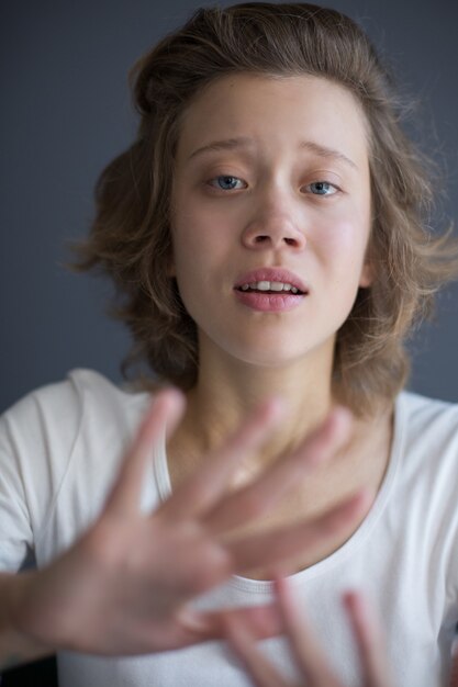 Vertical portrait of young lady frightenedly 