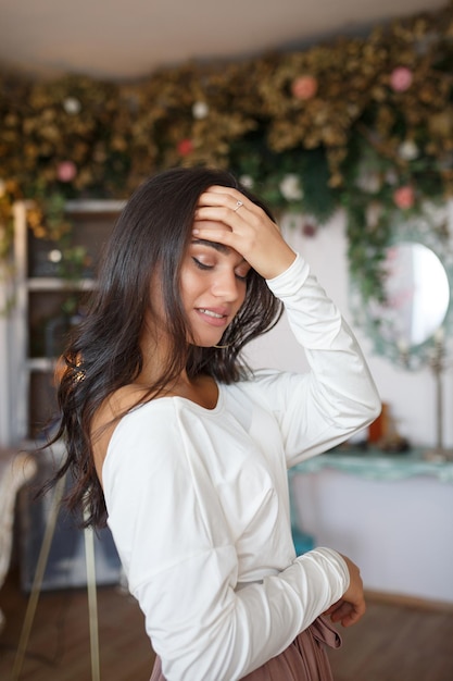 Vertical portrait of young lady put her hand to her forehead and closed her eyes High quality photo