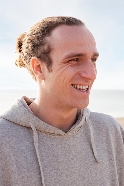 vertical portrait of a young man smiling happy