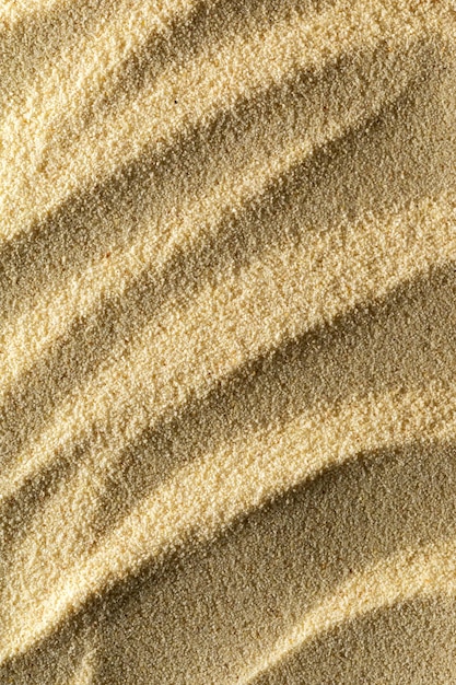 Vertical sandy light background format 23 with waves of sand macro