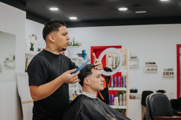 Vertical shoot of a hairdresser combing his customer with some copy space in the right side