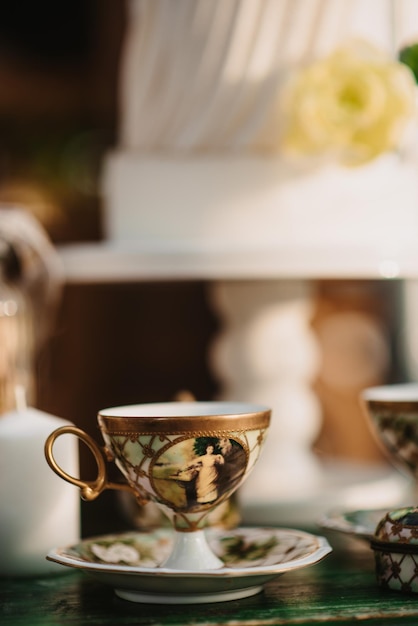 Vertical shot of an antique cup on a table with blurred background