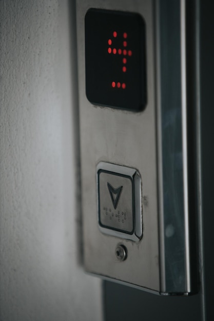 Vertical shot of a button of an elevator on the 4th floor