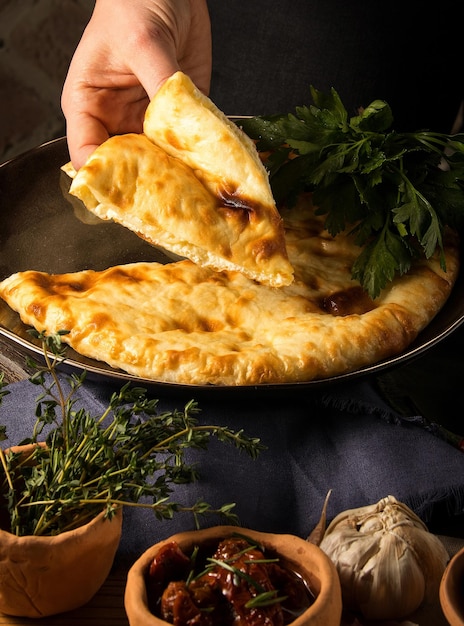 Vertical shot of a chef serving a gourmet Georgian dish