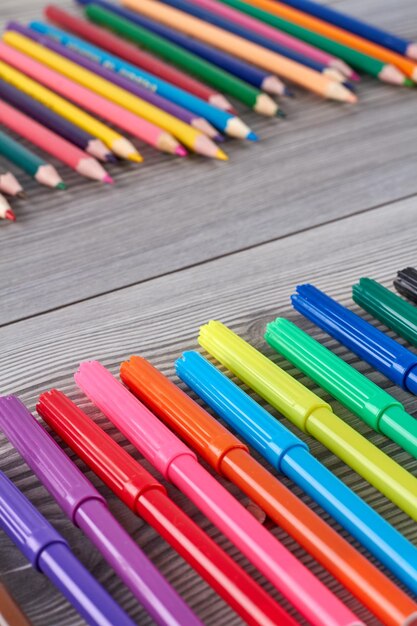 Vertical shot close up colorful felttip pens grey wooden desk