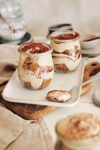 Vertical shot of delicious tiramisus served in a cup