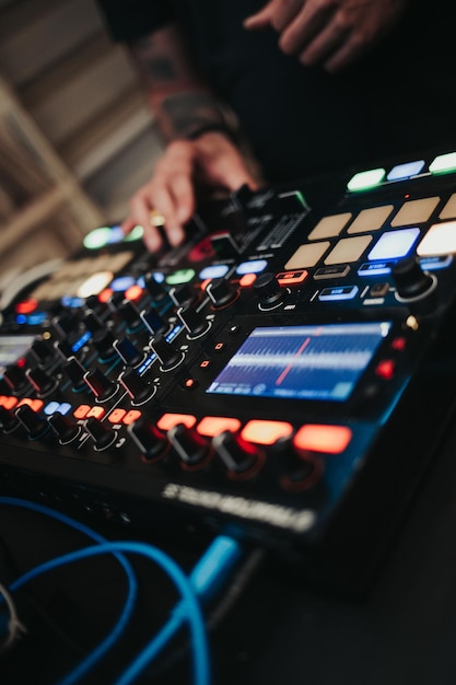 Vertical shot of the DJ working on his equipment at a party