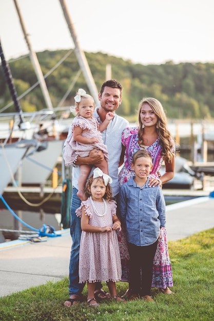 Vertical shot of a family posing for a picture at the port