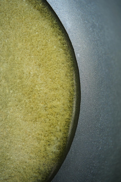 Vertical shot of homemade ghee in container on a table