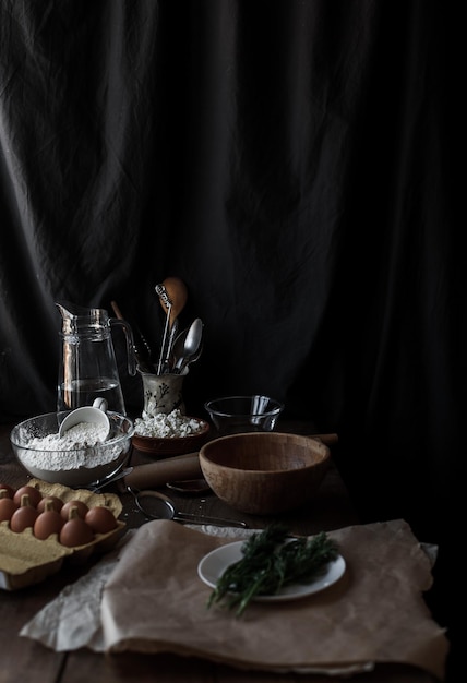 Vertical shot of a kitchen table with dough and ingredients for baking