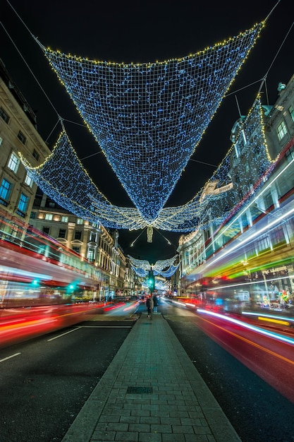 Vertical shot of the light trails on the night street london\
uk