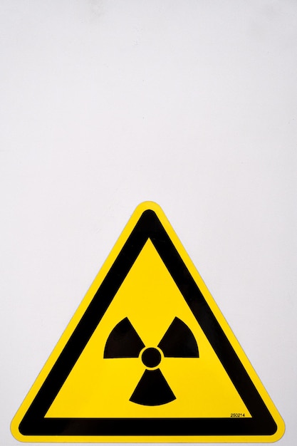 Vertical shot of a nuclear sign on a white background