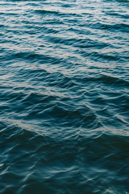 Vertical shot of ocean waves with shades of blue - great for wallpapers