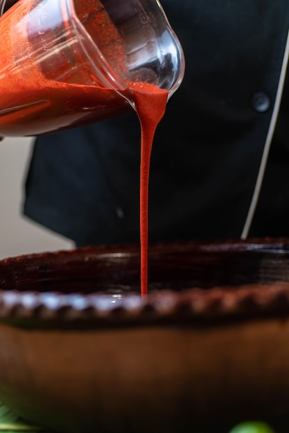 Vertical shot of the process of making achiote Condimented sauce for Cochinita Pibil