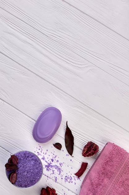 Vertical shot purple bath accessories on white desk.