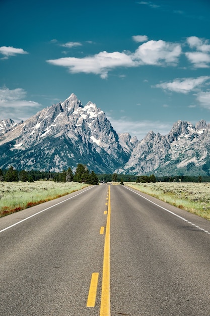 Photo vertical shot of a road leading to grand teton national park, wyoming usa
