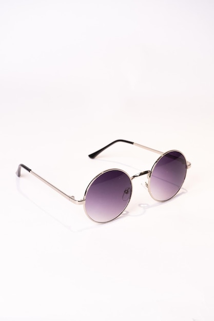 Vertical shot of a round sunglasses isolated on a white background