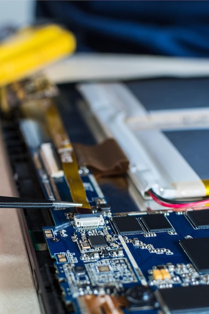 Vertical shot of smart phone and tablet repair in a technology lab.