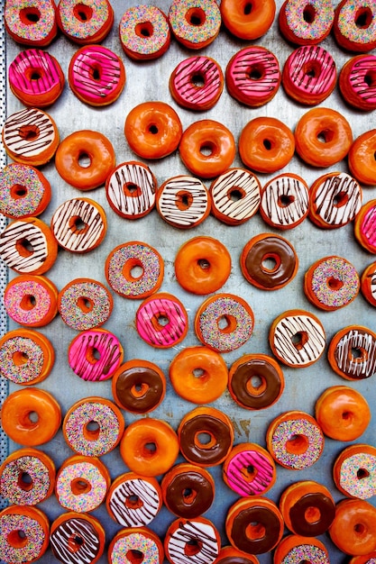 Vertical shot of various colorful delicious donuts