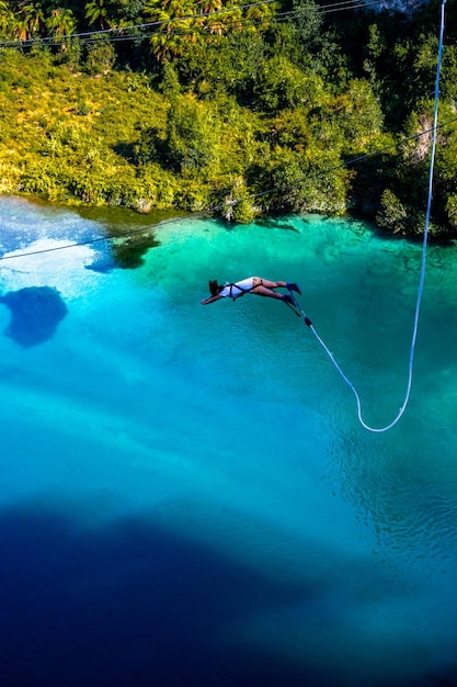 Vertical shot of a woman doing bungee jumping in Taupo, New Zealand