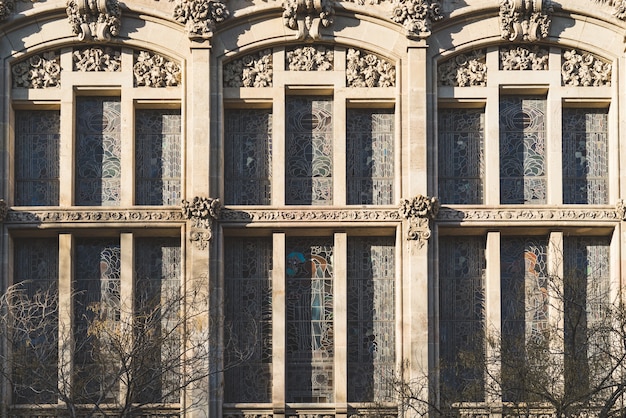 Vertical stained glass windows and ornamental elements of the facade of a classic modernist building