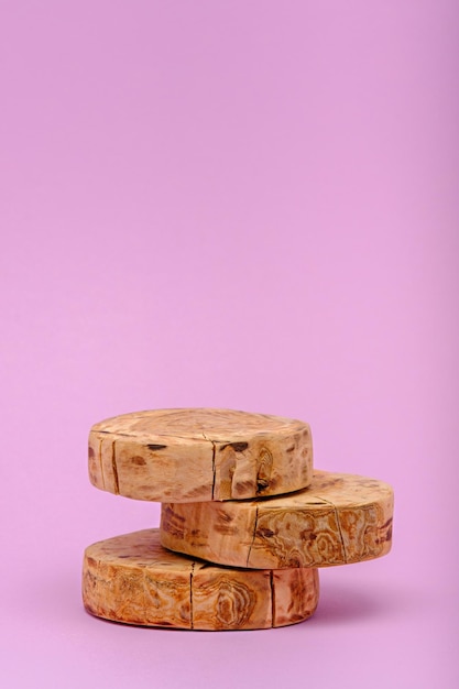 Vertical three wooden sawn podium on pink background ecoscene
showcase concept