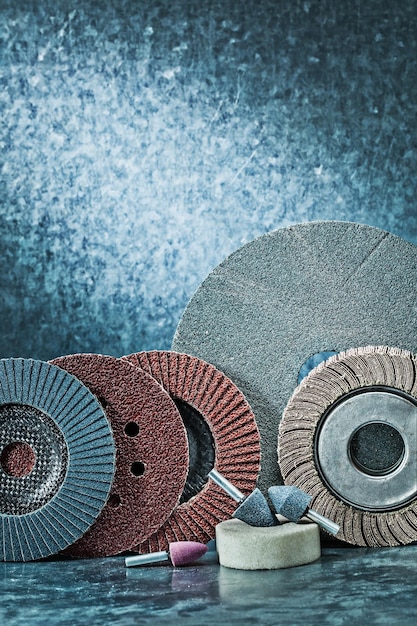 Vertical version set of abrasive tools on metalic background