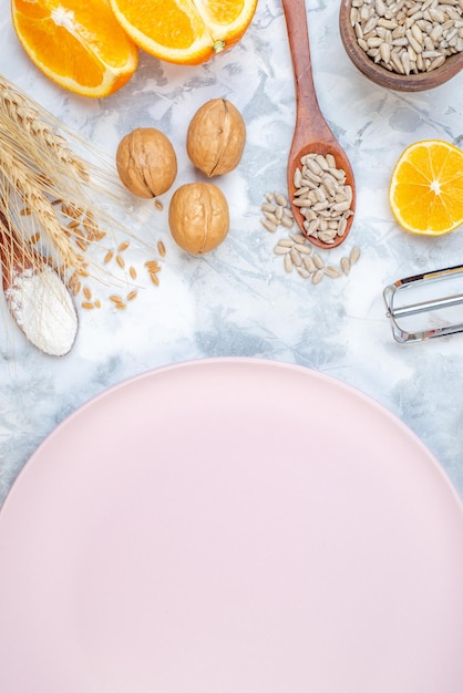 Vertical view of empty white plate and fresh healthy food set on two-toned background