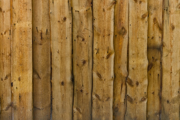 Vertical wooden untreated brown boards with nails and twigs Background