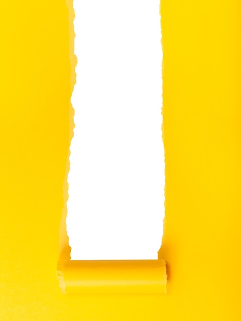 Vertical yellow rolledup torn paper on white