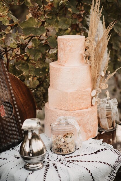 Foto verticale close-up van een kleine glazen pot koekjes met een grote taart op tafel