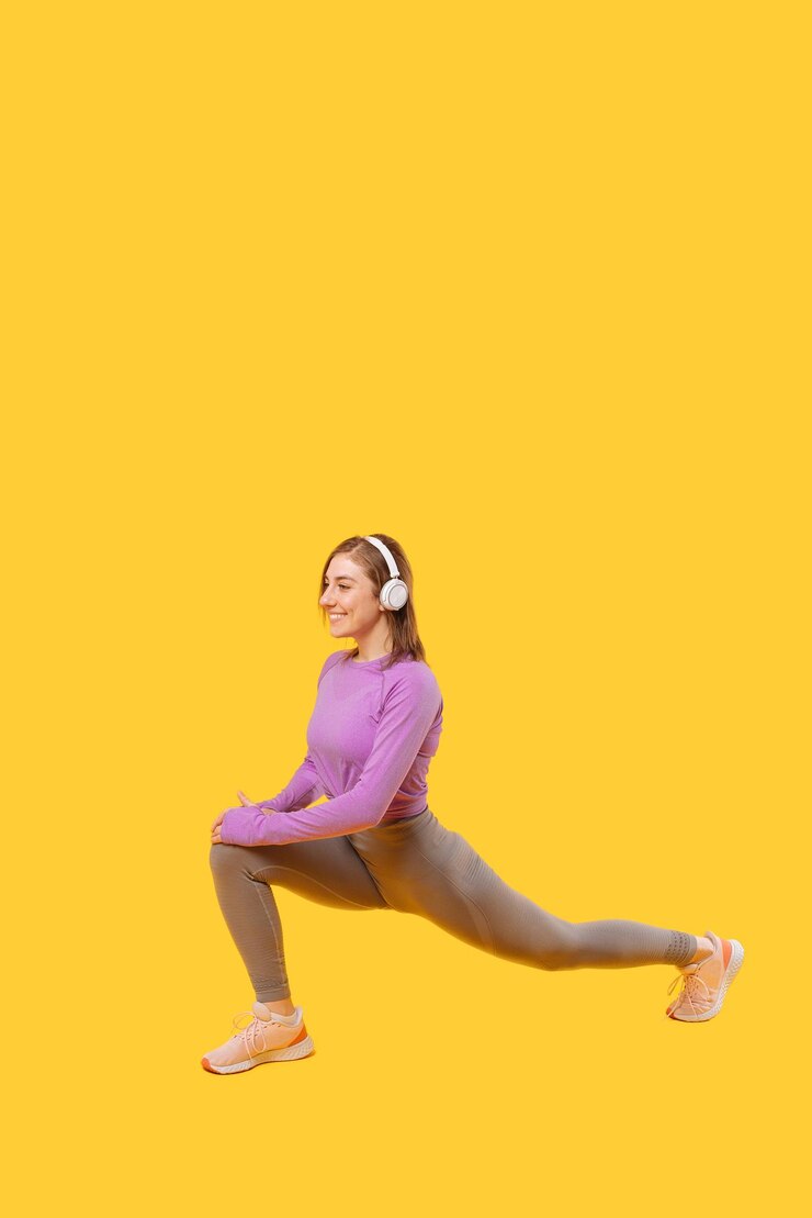 Verticale foto van een jonge vrouw die lunges uitvoert terwijl ze naar de muziek luistert