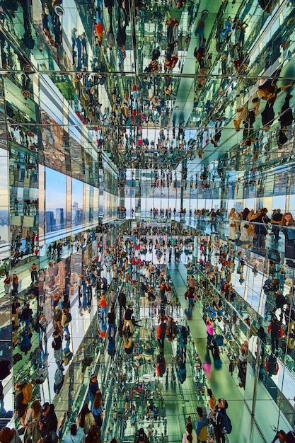 Verticale kamer van honderden toeristen die overal in spiegels reflecteren in de wolkenkrabber met uitzicht op Nieuw