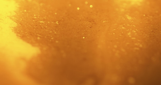 Vervagen glitter textuur Gouden achtergrond Bokeh licht Macro gloeiend oppervlak Intreepupil geel oranje kleur glinsterende sparkles reflectie abstracte kunst banner