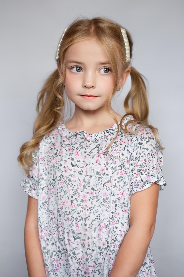 A very beautiful dress for a girl, curly hair on a white background, a bright girl child