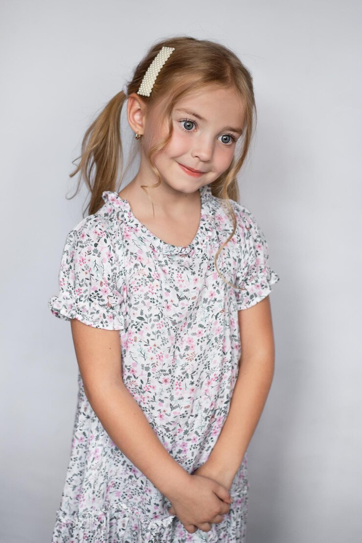 A very beautiful dress for a girl, curly hair on a white background, a bright girl child